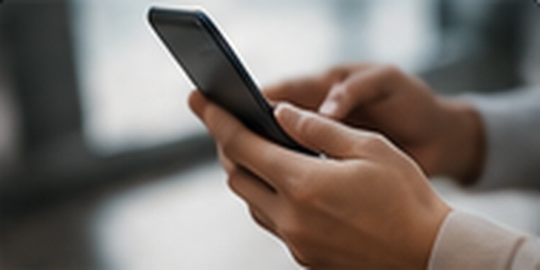 Professional reviewing marketing on a smartphone